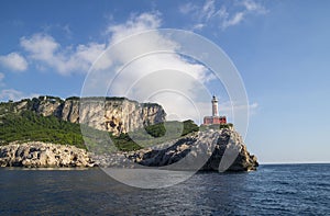 Punta Carena Lighthouse on the coastal rocks in Capri island