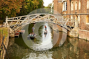 Punts passing under the historic Mathematical Bridge on the River Cam in Cambridge