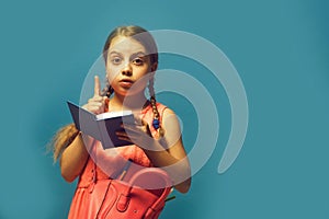 Pupil with braids, isolated on blue background with copy space