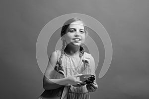 Pupil with braids, isolated on blue background. Childhood concept