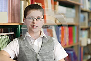 Pupil in grey jacket and spectacles on background photo
