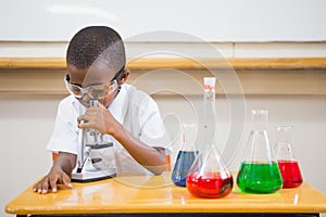 Pupil looking through microscope