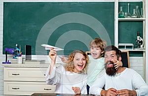 Pupil with paper airplane dreams of education. Happy school kids at lesson in September 1. Home Family math schooling -