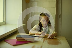 Pupil in school uniform with braids. Back to school and education concept