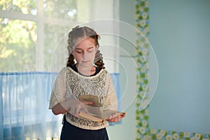 Pupil in school uniform with braids. Back to school and education concept