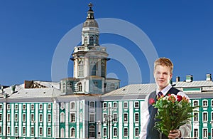 Pupil in a school uniform with a bunch of flowers