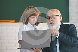 Pupil and senior teacher in classroom. Education concept. School learning concept. Boy elementary school.