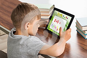 Pupil Solving Math Problem On Digital Tablet