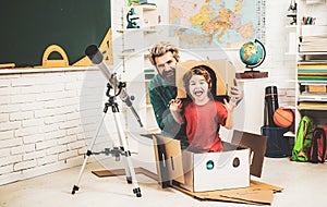 Pupil studies astronomy with funny teacher. Pupil enjoy time with teacher father. Child playing with paper rocket.