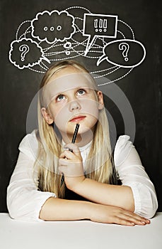 Pupil thinking in classroom, education concept, girl with question mark icons above her head