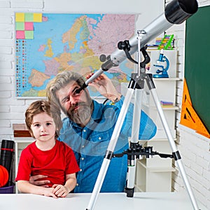 Pupil watching stars with a teacher. Astronomy telescope. Father teaching son.