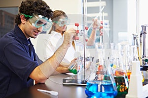 Pupils Carrying Out Experiment In Science Class