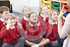 Pupils Copying Teacher's Actions Whilst Singing Song photo