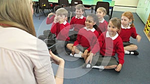 Pupils Copying Teacher's Actions Whilst Singing Song