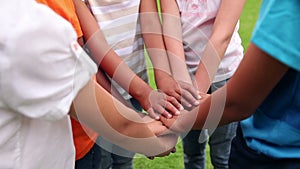 Pupils holding hands together and cheering outside