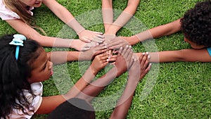 Pupils holding hands together outside