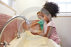 Pupils At Montessori School Washing Hands In Washroom