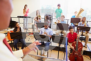 Pupils Playing Musical Instruments In School Orche