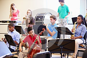 Pupils Playing Musical Instruments In School Orchestra