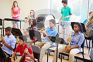 Pupils Playing Musical Instruments In School Orchestra