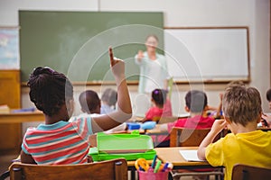 Pupils raising their hands during class