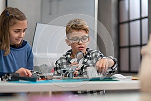 Pupils at school working with electronics component at robotics classroom.