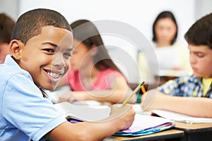 Pupils Studying At Desks In Classroom