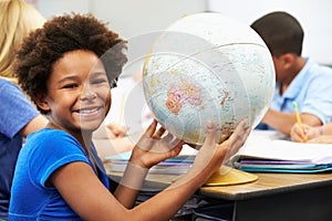 Pupils Studying Geography In Classroom photo