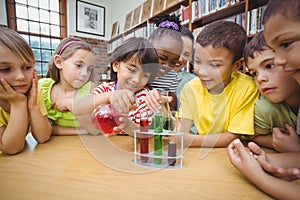 Pupils and teacher doing science in library