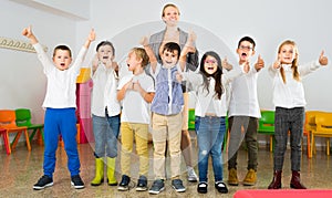 Pupils with teacher posing, giving thumbs up