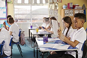 Pupils using tablet computers in class at a primary school
