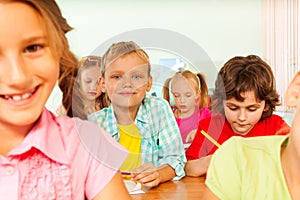 Pupils write in exercise books during lesson