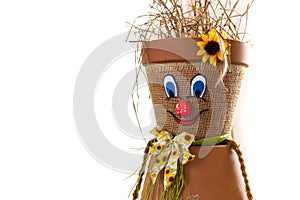 Puppet made of flowerpots and straw sitting on a board