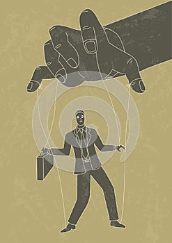 Puppet master controlling a businessman