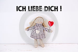 Puppet with a red heart and a `Ich liebe dich!` text: Translation: `I love you`