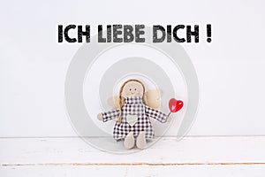 Puppet with a red heart and a `Ich liebe dich!` text: Translation: `I love you`