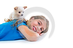 Puppy chihuahua dog on kid girl lying happy smiling