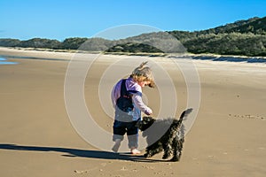 Puppy and child on the beach