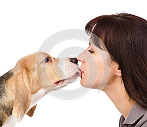 Puppy kisses woman. isolated on white background