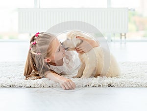 Puppy kissing little girl