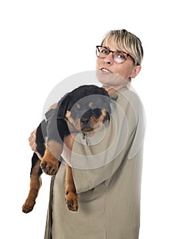 Puppy rottweiler and woman in studio