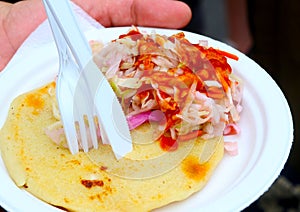 Pupusa with coleslaw at street fair