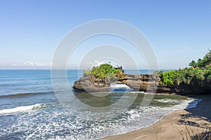 Pura Batu Balong Temple on Segara Batu Balong Beach, Ubud, Bali, Indonesia or Temple with a hole in the stone