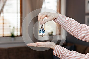Purchase of real estate. Realtor shows keychain and keyring. Close up of hands. Concept of leasing, business and