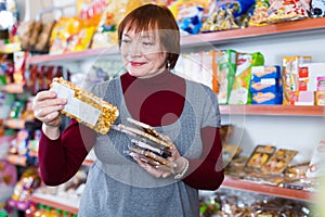 Purchaser holding honey and nut bar in packaging