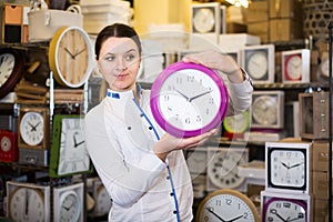 purchaser is standing with wall clock