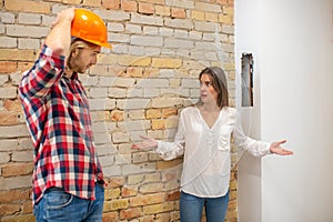 Purchaser talking to the construction worker and looking unpleased