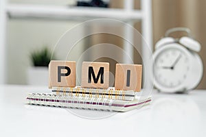 Purchasing Managers Index concept. Text PMI on wood cube. Index used as indicator of economic health of manufacturing and service