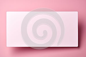 Pure backdrop: Blank white card isolated on pastel pink, ready for your sentiments. photo