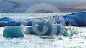 Pure blue ice in arctic. Icebergs breakaway from glacier in Iceland. Crystal clear blue ice floats in salt turquoise